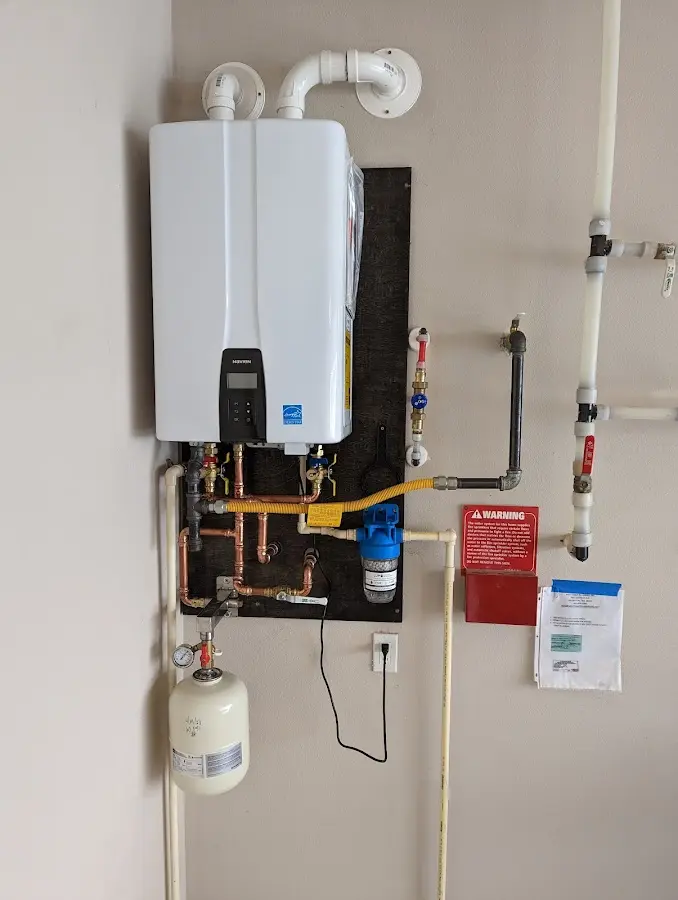 Professional plumber installing copper piping in a Bluffton home